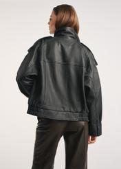 Women's black leather jacket KURDS-0554-2701(Z25) - back view of the product on a model, against a white background. Knee-length silhouette visible.
