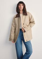 Beige women's oversize jacket KURDT-0615-81(Z25), front view of the product on the model. Half of the silhouette visible.