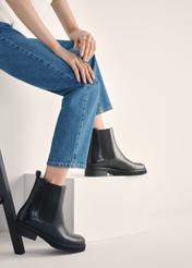 Women's black leather Chelsea boots BUTYD-1196-99(Z25) - side view of the product on a model against a white background. Knee-length silhouette visible.