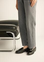 Women's leather moccasins with tassel BUTYD-1295-9F(Z26) - side view of the product, on the model's feet, on a light background.