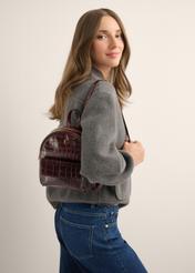 Burgundy croco women's leather backpack TORES-1323-4D(Z26), front view of the product on a model. Half of the silhouette visible.