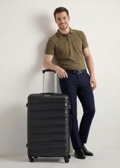 Large suitcase on wheels WALAB-0081-99-28(W26), front view of the product next to the model's silhouette.