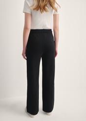 Black women's trousers SPODT-0111-99(Z25), back view of the product on the model. Half of the silhouette visible.