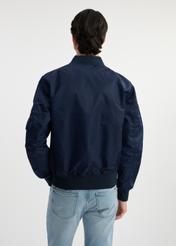 Navy men's TOP GUN KURMT-0381-69(W25) pilot jacket - back view on model on white background. Half of the silhouette visible.