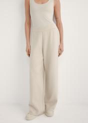 Beige women's wide leg trousers SPODT-0121-1A(W26), front view of the product on the model. Half of the silhouette visible.