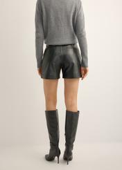 Women's black leather shorts SPODS-0007-99(KS), back view of the product on the model. Half of the silhouette visible.