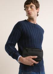 Black men's cosmetic bag TORMN-0429-99(Z26), front view of the product on the model. Half of the silhouette visible.