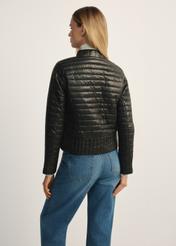Black women's quilted jacket with a stand-up collar KURDT-0441-99(Z25), product view from the back on the model, half of the silhouette visible.