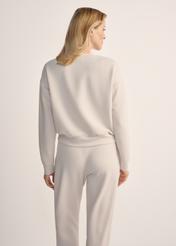 Light beige women's sweatshirt BLZDT-0119-80(Z25), back view of the product on the model. Half of the silhouette visible.