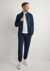 Men's navy blue zip-up sweatshirt BLZMT-0072-7E(W26), front product view on model. Full body visible.