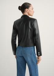 Women's short leather jacket KURDS-0522-99(W26) - back view of the product, on a model, against a light background. Half of the silhouette visible.