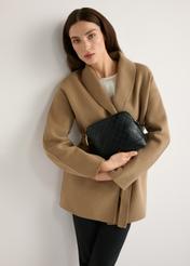 Black monogrammed women's handbag TOREC-1180-9P(W26), product view in model's hands. Half of silhouette visible.