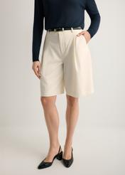 Women's cream wool shorts SZODT-0021-0B(W26), front view of the product on the model. Half of the silhouette visible.