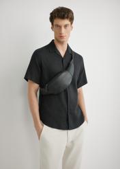 Men's black leather waist bag TORMS-0497-99(W26), front product view on the model's silhouette.