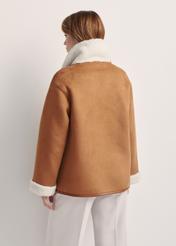 Women's sheepskin coat in camel color KOZDP-0013-24(Z25) - product view from the back on a model on a white background. Half of the silhouette visible.