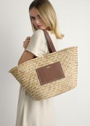 Women's straw shopper bag TOREC-1219-1E(W26), front product view, on a model, on a light background.