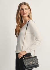 Black women's handbag with monogram TOREC-1155-99(W26), front view of the product on a model, half of the silhouette visible.