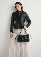 Black TOREC-1215-99(W26) bucket bag - front view of the product, held by the model, against a light background. The entire silhouette is visible.