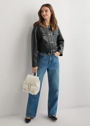 Cream TOREC-1195-0A(W26) women's quilted backpack - front view of the product, held by the model, against a light background. The entire silhouette is visible.