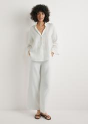 Light beige linen women's trousers SPODT-0124-1A(W26), front view of the product on the model, the whole silhouette is visible.
