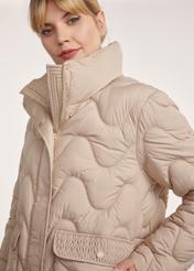 Beige women's quilted jacket KURDT-0606-81(Z25), close-up of product detail on model on white background.