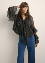 Women's black blouse with a lilac pattern BLUDT-0212-9P(Z26), front view of the product on the model. Half of the silhouette visible.