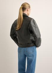 Women's leather biker jacket KURDS-0605-99(W26), back view of the product on the model. Half of the silhouette visible.