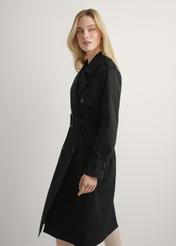 Long black women's jacket in the form of a coat KURDT-0512-99(W25), product view from the side on the model, half of the silhouette visible.