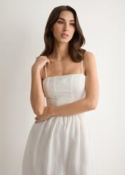 White linen midi dress with straps SUKDT-0279-0B(W26), front view of the product on the model. Half of the silhouette visible.
