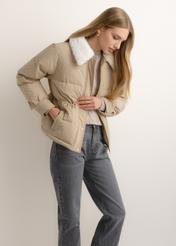 Women's short beige jacket KURDT-0695-1B(Z26), side view of the product on the model. Half of the silhouette visible.