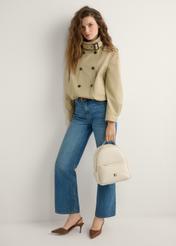 Cream women's medium backpack TOREC-0920-0B(W26), product view in model's hand. Full body visible.