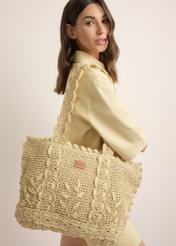 Light beige straw shopper bag TOREC-1222-1E(W26), product view on model's shoulder. Half of silhouette visible.
