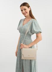 Cream women's messenger bag TOREC-0899A-12(W25) - view of the bag on the model. Visible silhouette.