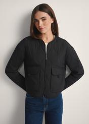Black women's transitional nylon jacket KURDT-0656-99(W26), front view of the product on the model, half of the silhouette visible.