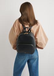 Women's leather backpack in black TORES-1276-9I(W26), front view of the product on the model's silhouette.