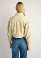 Light yellow women's leather jacket KURDS-0574-2A(W26), back view of the product on the model. Half of the silhouette visible.