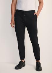 Black men's sweatpants SPOMT-0101-99(Z25), product view from the front on the model, half of the silhouette visible.