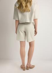 Women's cream leather shorts SPODS-0047-0B(W26), back view of the product on the model. Half of the silhouette visible.