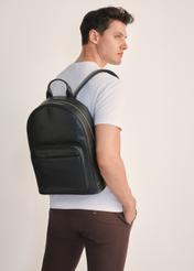 Black men's leather backpack TORMS-0472-99(Z25), front view of the product on the model, half of the silhouette visible.