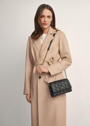 Small quilted women's handbag in black TOREC-1150-99(W26), front view of the product on a model, half of the silhouette visible.