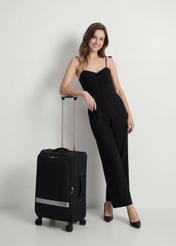 Medium suitcase on wheels WALNY-0044-99-24(W26), diagonal view of the product next to the model's silhouette.