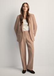 Beige elegant women's trousers SPODT-0106A-1D(W26), front view of the product on the model. Full body visible.