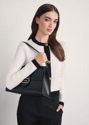 Elegant black women's handbag TOREC-1068-99(Z25) - diagonal view of the product on a model, against a white background. Half of the silhouette is visible from the side.