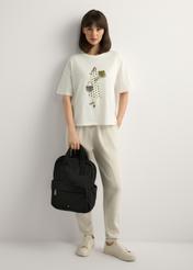 Black nylon women's backpack TOREN-0341-99(W26), product view in model's hand. Full body visible.