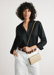 Small beige leather women's handbag TORES-1043-1B(W26) - front view of the product, on a model, against a light background. Knee-length silhouette visible.