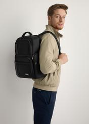Black men's backpack TORMN-0406-99(W26), diagonal view of the product on the model's silhouette.