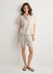 Women's light beige linen shorts SZODT-0019-1A(W26), front view of the product on the model. Full body visible.