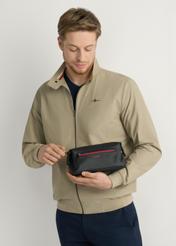 Black men's cosmetic bag TORMN-0397-9J(W26), view of the product in the model's hand, on a light background.