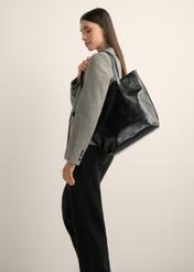 Large black women's glossy shoulder bag TORES-1368-9F(Z26), product view on model's shoulder. Half of silhouette visible.
