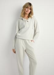 Light beige women's hooded sweatshirt BLZDT-0111A-1A(W26), front view of the product on the model. Half of the silhouette visible.